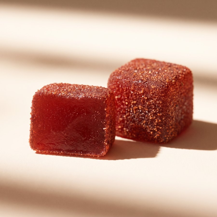 Two Spicy Cubes in close-up: one showing the chili-tamarind coating on all sides, the other cut to show the translucent interior